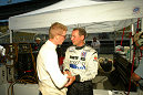 Butch Leitzinger is congratulated by a Dyson Racing crew member after earning the pole