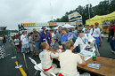 Johnny Herbert and JJ Lehto of ADT Champion Racing sign autographs