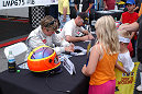 Melanie Paterson and co-driver Jason Workman sign autographs for young fans