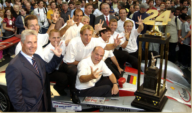 Motorsport fans celebrate the Le Mans success. Together with the winners trophy, which after the third successive Le Mans victory remains in Ingolstadt forever: The winning drivers (in the middle Frank Biela) with Head of Audi Sport Dr Wolfgang Ullrich (middle below) and chairman of the board AUDI AG Dr Martin Winterkorn (right back), Dr Jochem Heizmann, member of the board production (left back) and Dr Werner Mischke, member of the board technical development (front left)