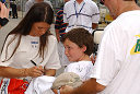 Danica Patrick signs an autograph for a young admirer