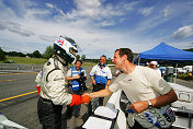 James Weaver (left) receives congrats from co-driver Butch  Leitzinger after winning pole