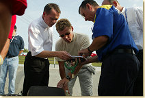 Tom Kristensen (center) with race engineer Ed Turner (left)