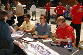 American Le Mans Series drivers (l-r) Craig Stanton, Johnny Mowlem and Jan Magnussen sign autographs for fans after doing demonstration laps on Market Street