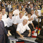 Motorsport fans celebrate the Le Mans success. Together with the winner's trophy, which after the third successive Le Mans victory remains in Ingolstadt forever: The winning drivers (in the middle Frank Biela) with Head of Audi Sport Dr Wolfgang Ullrich (middle below) and chairman of the board AUDI AG Dr Martin Winterkorn (right back), Dr Jochem Heizmann, member of the board production (left back) and Dr Werner Mischke, member of the board technical development (front left)